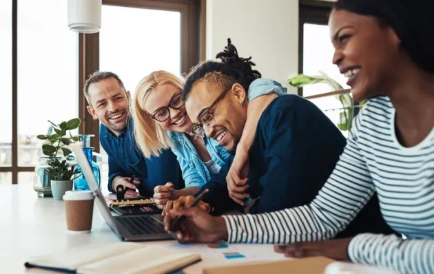 Image of four people laughing