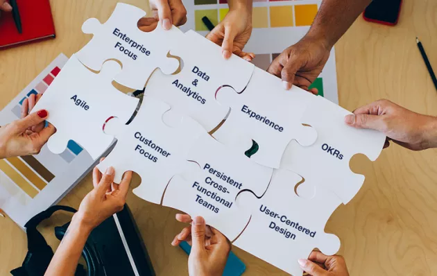 Photo of people holding up puzzle pieces